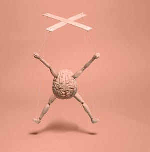 a model figure resembling a puppet with a brain as its torso and wooden limbs suspended by strings