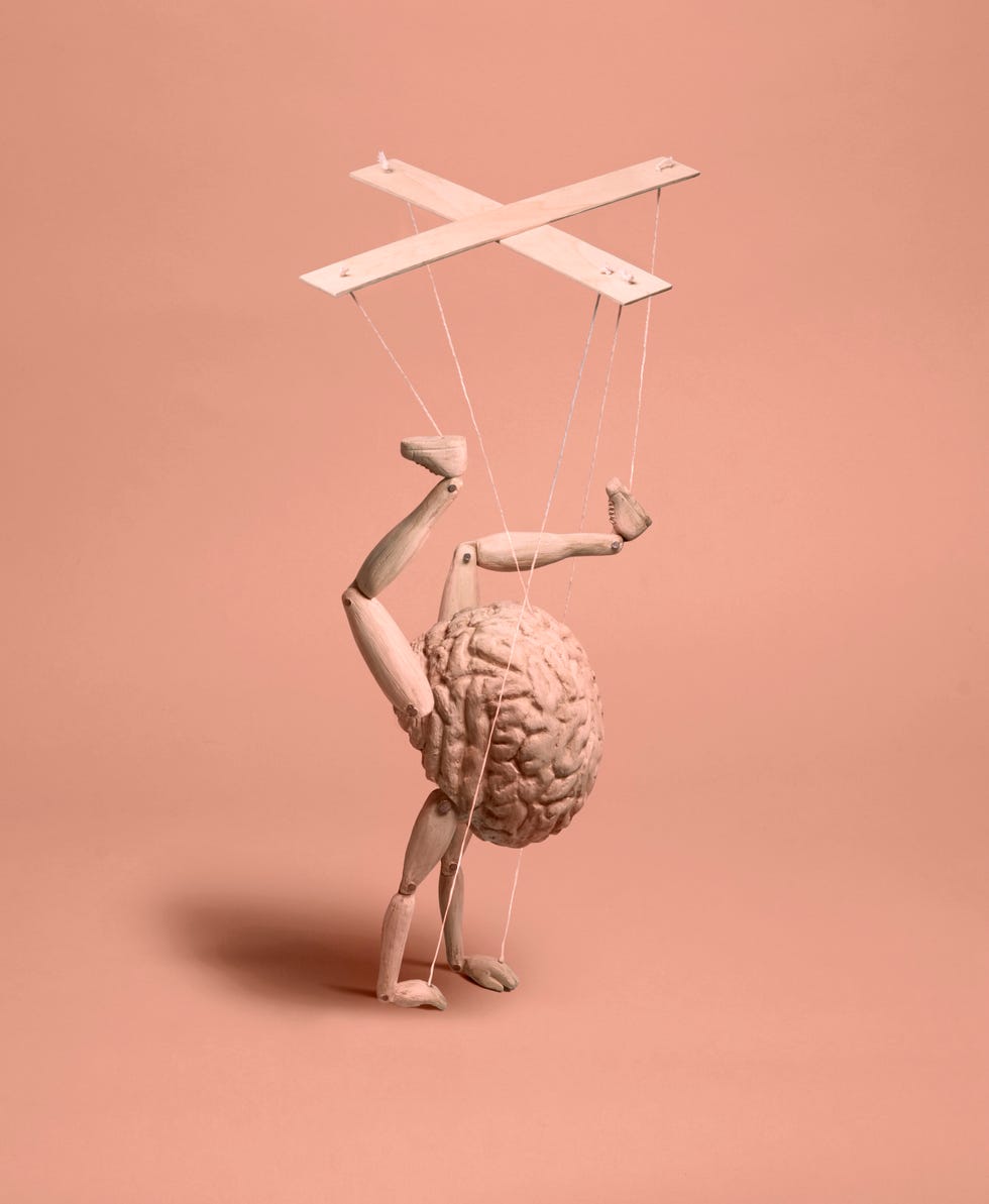 a wooden brain with arms and legs, resembling a puppet, doing a handstand