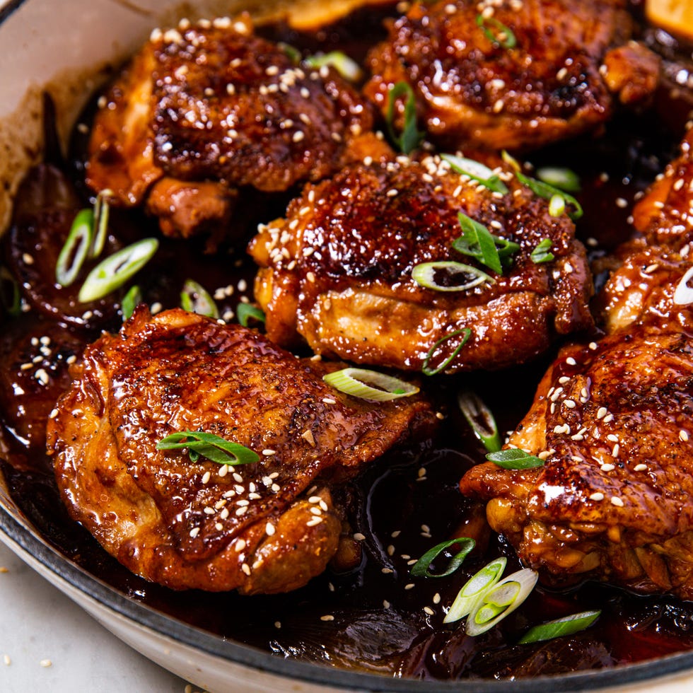 braised chicken thighs in a sauce with green onions