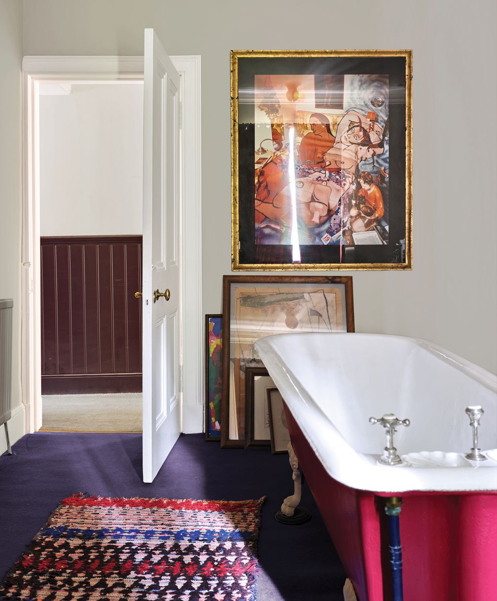 Magenta vintage tub in guest bathroom and purple floor