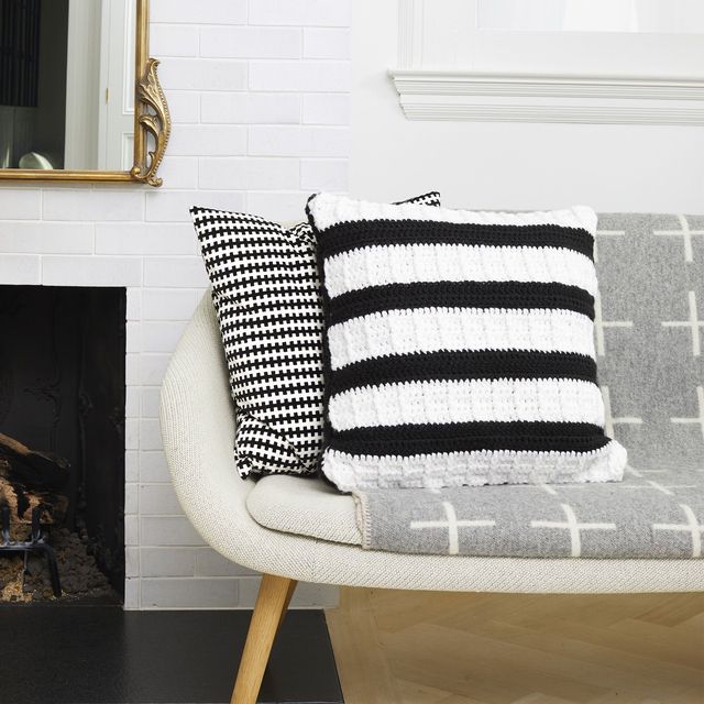 adult craft ideas, black and white crochet pillow on the couch