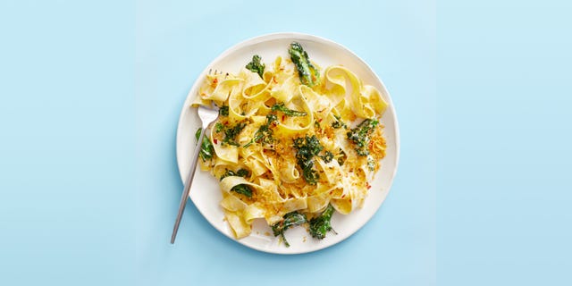 a plate of pasta with greens and breadcrumbs