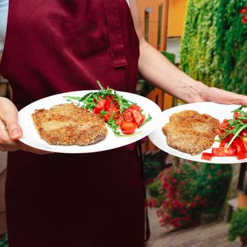 breaded cutlets with fresh tomato arugula salad.