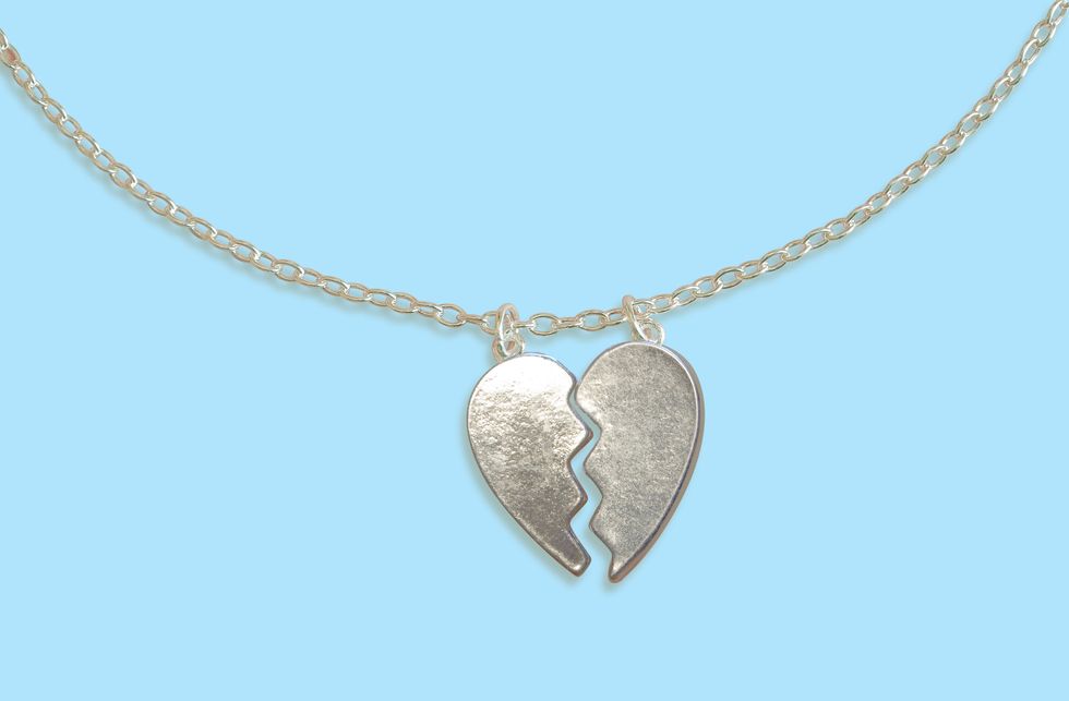Broken heart necklace on blue background