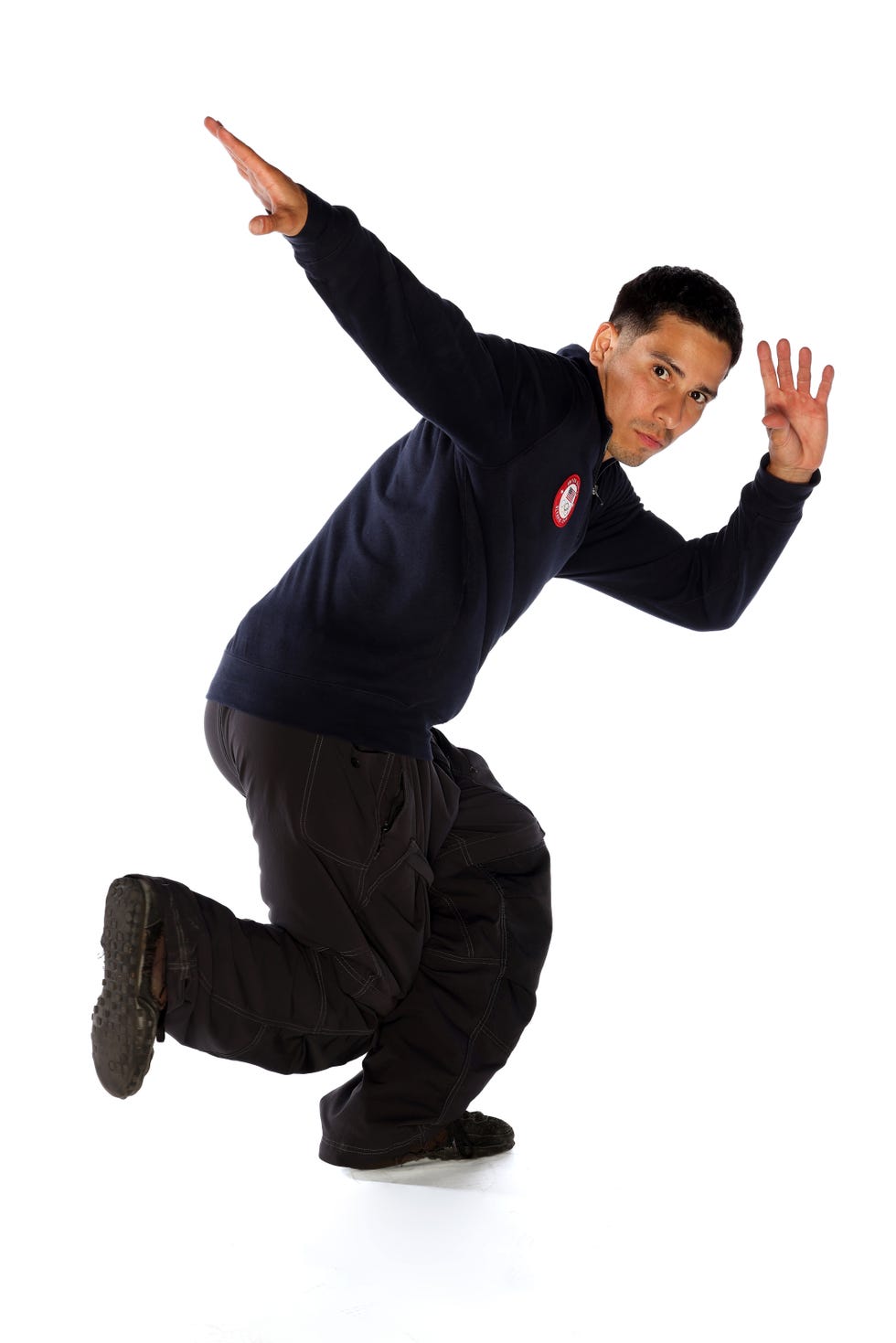 us breakdancer victor montalvo holding a dance pose in front of a white background