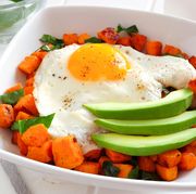 breakfast bowl close up with sweet potato, egg, avocado and spinach