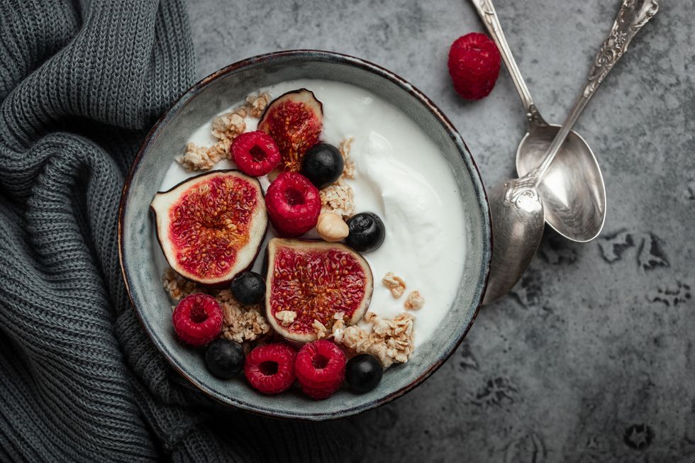 breakfast bowl with oat granola yogurt figs raspberries blueberries