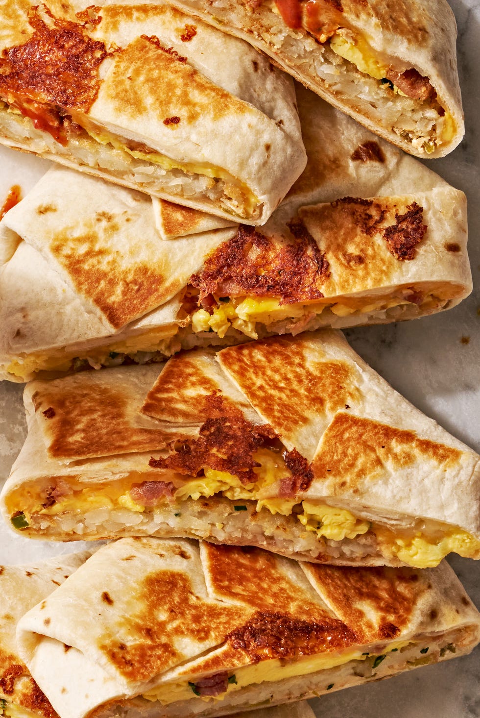 Breakfast Crunchwrap Supreme crunchwrap layered with eggs, hashbrowns, and bacon