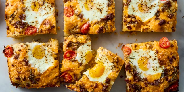 classic focaccia reimagined into the ultimate breakfast with crispy edges, layers of crumbled breakfast sausage, shredded cheese, and juicy cherry tomato and jammy eggs.