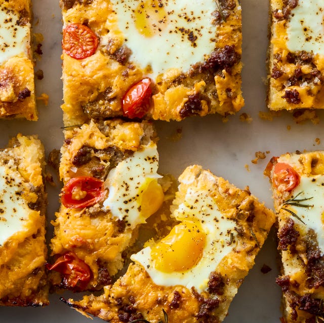 Breakfast Focaccia classic focaccia reimagined into the ultimate breakfast with crispy edges, layers of crumbled breakfast sausage, shredded cheese, and juicy cherry tomato and jammy eggs.