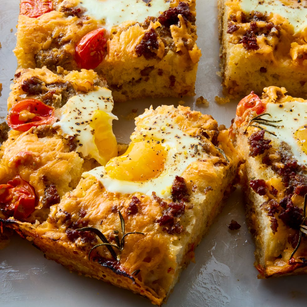 classic focaccia reimagined into the ultimate breakfast with crispy edges, layers of crumbled breakfast sausage, shredded cheese, and juicy cherry tomato and jammy eggs.