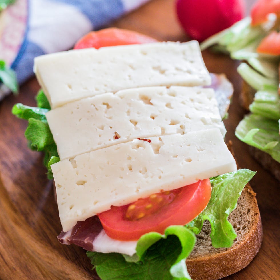 Breakfast on table, sandwiches with pancetta, havarti cheese and veggies on table breakfast on table, sandwiches with pancetta, havarti cheese and veggies on table