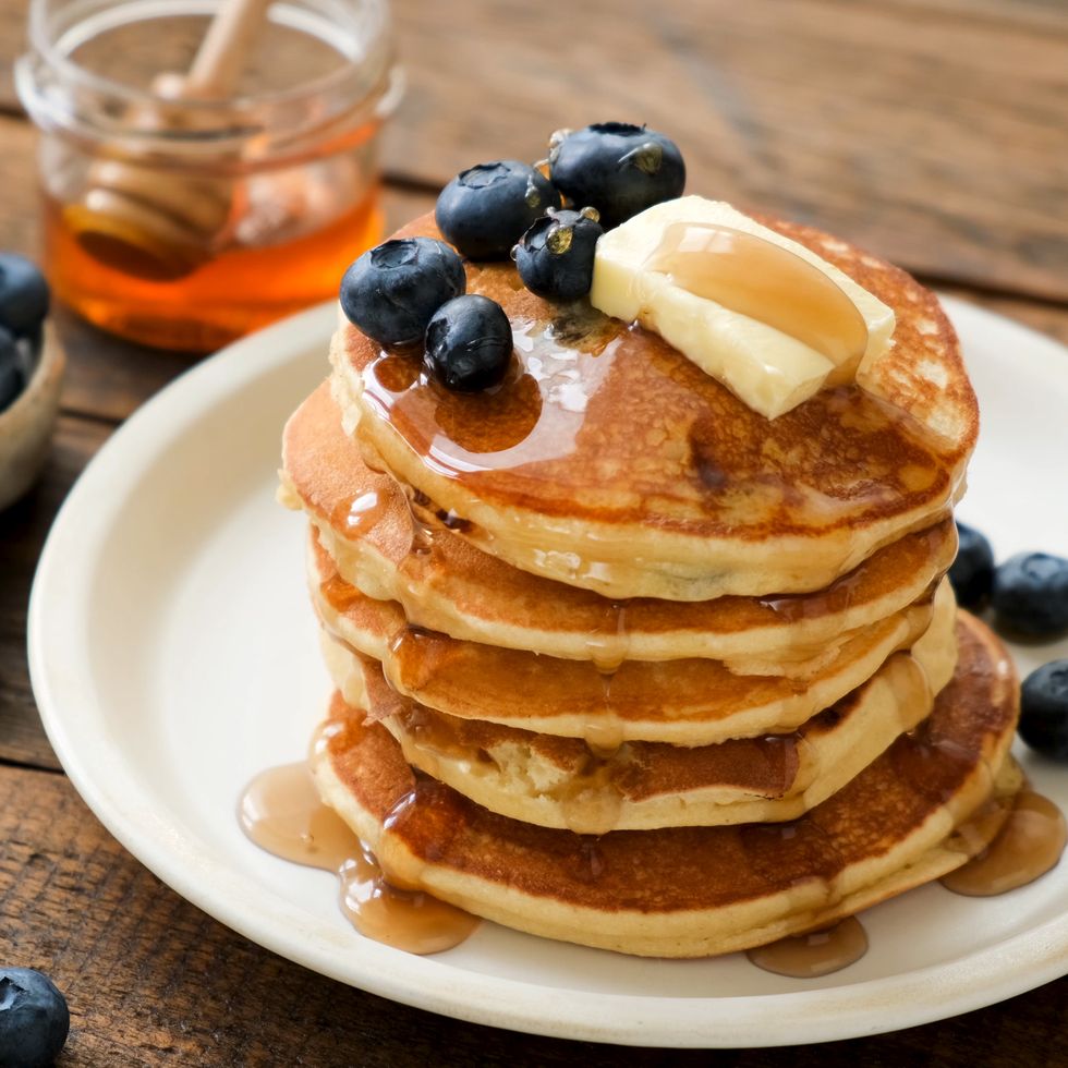 breakfast pancakes with blueberries, butter and honey