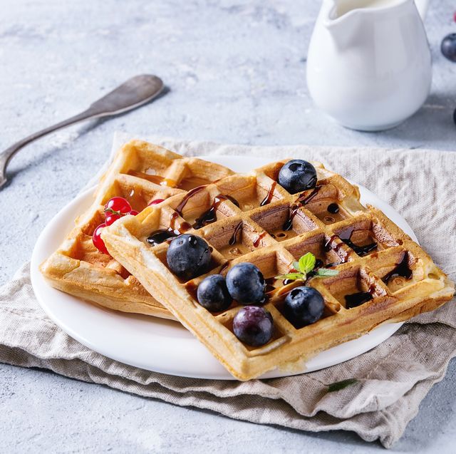 https://hips.hearstapps.com/hmg-prod/images/breakfast-with-homemade-square-belgian-waffles-with-fresh-news-photo-957721990-1542037529.jpg?crop=0.670xw:1.00xh;0.207xw,0&resize=640:*