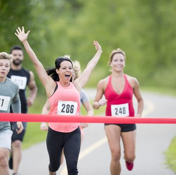 breaking the ribbon at the finish line