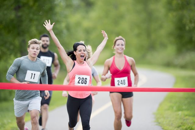 breaking the ribbon at the finish line