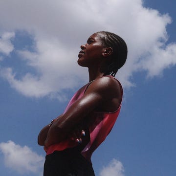 a confident individual standing against a blue sky with clouds arms crossed a confident individual standing against a blue sky with clouds arms crossed