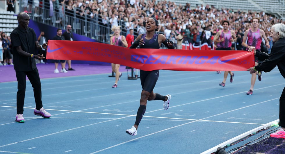 athlete breaking through the finish line at a running event