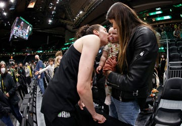 breanna stewart kisses her daughter ruby while wife marta holds her