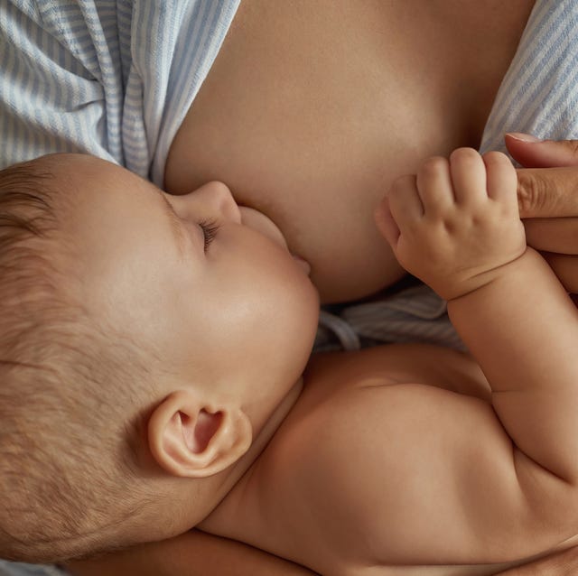 sweet little child, breastfeeding and having nap in mothers arms