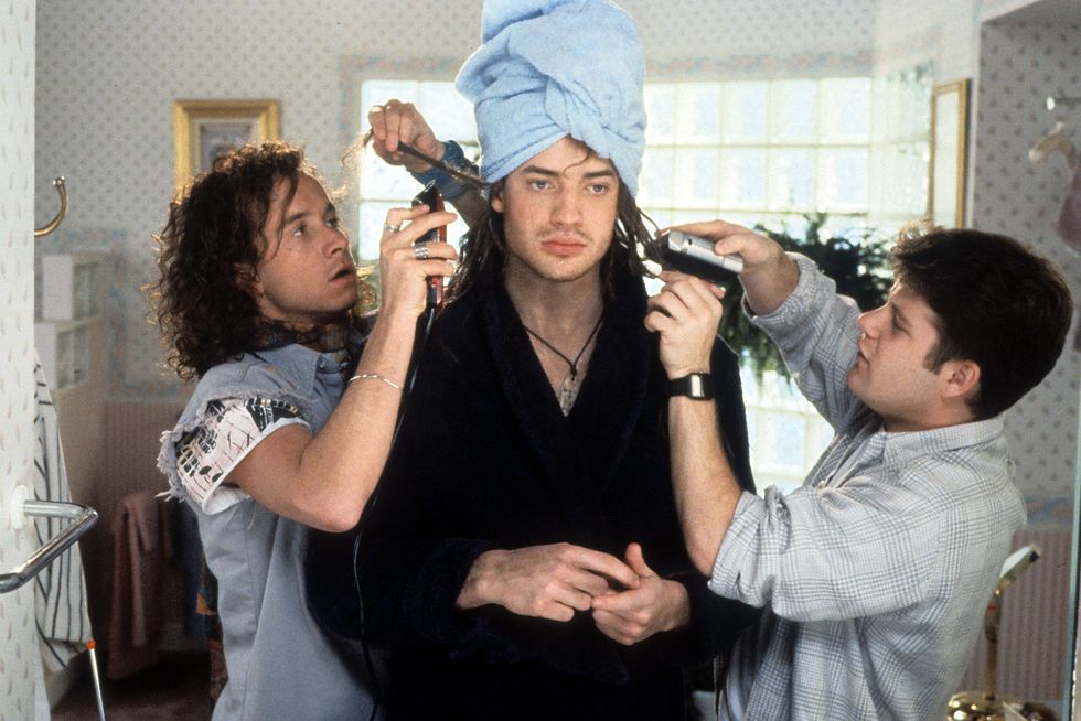 sean astin, brendan fraser, and pauly shore in character for encino man, astin and shore groom fraser who wears a bath towel and towel on his head