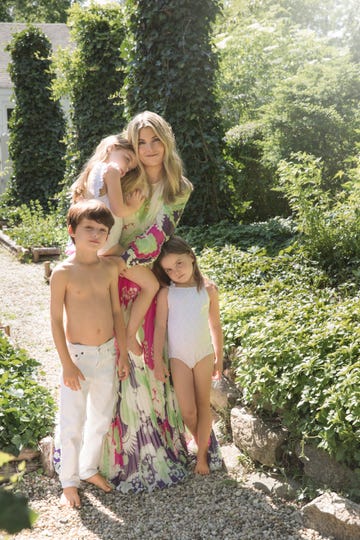 jewelry designer brent neale photographed with her three children in a lush garden setting