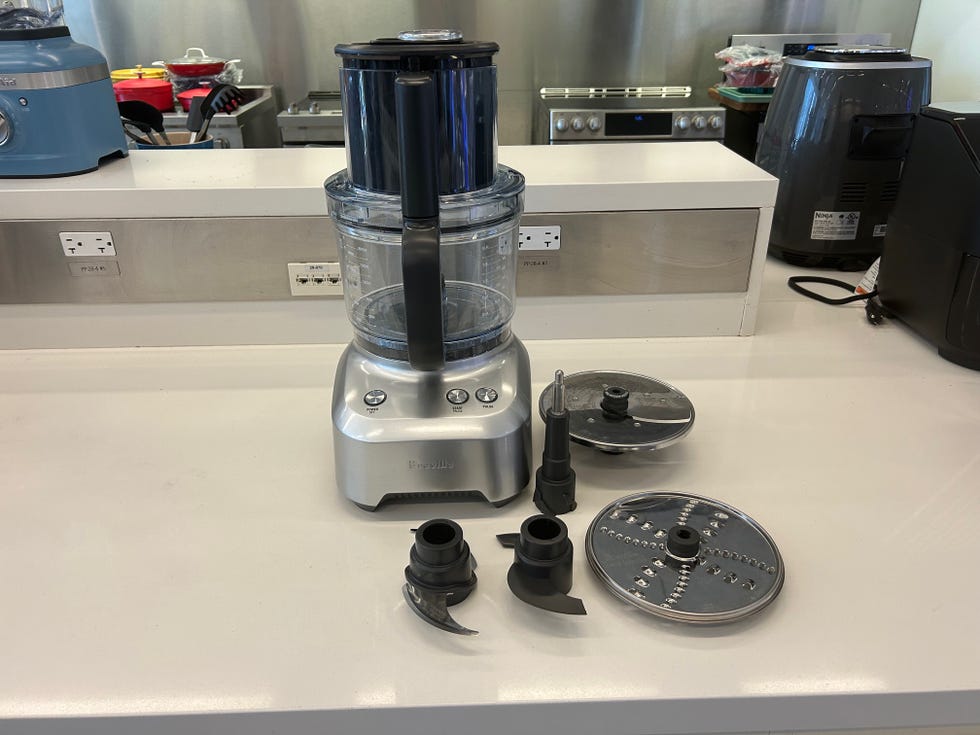 food processor with attachments on a kitchen countertop