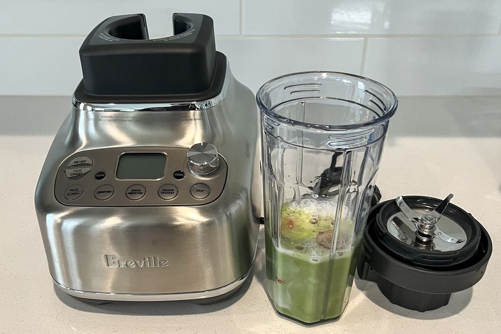 breville blender with green smoothie in cup