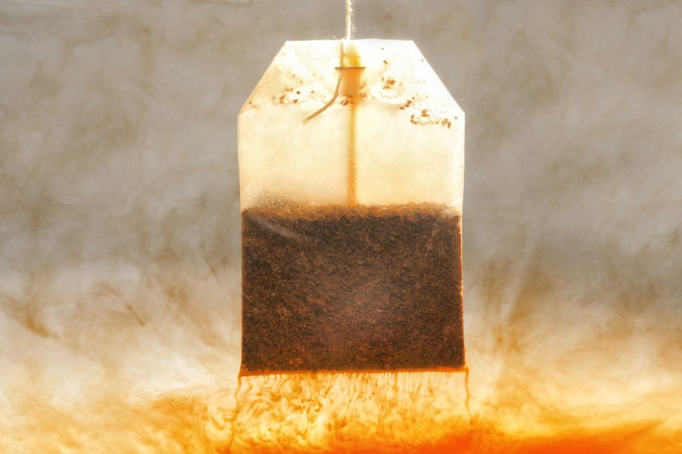 Brewing tea with bag in hot water, closeup