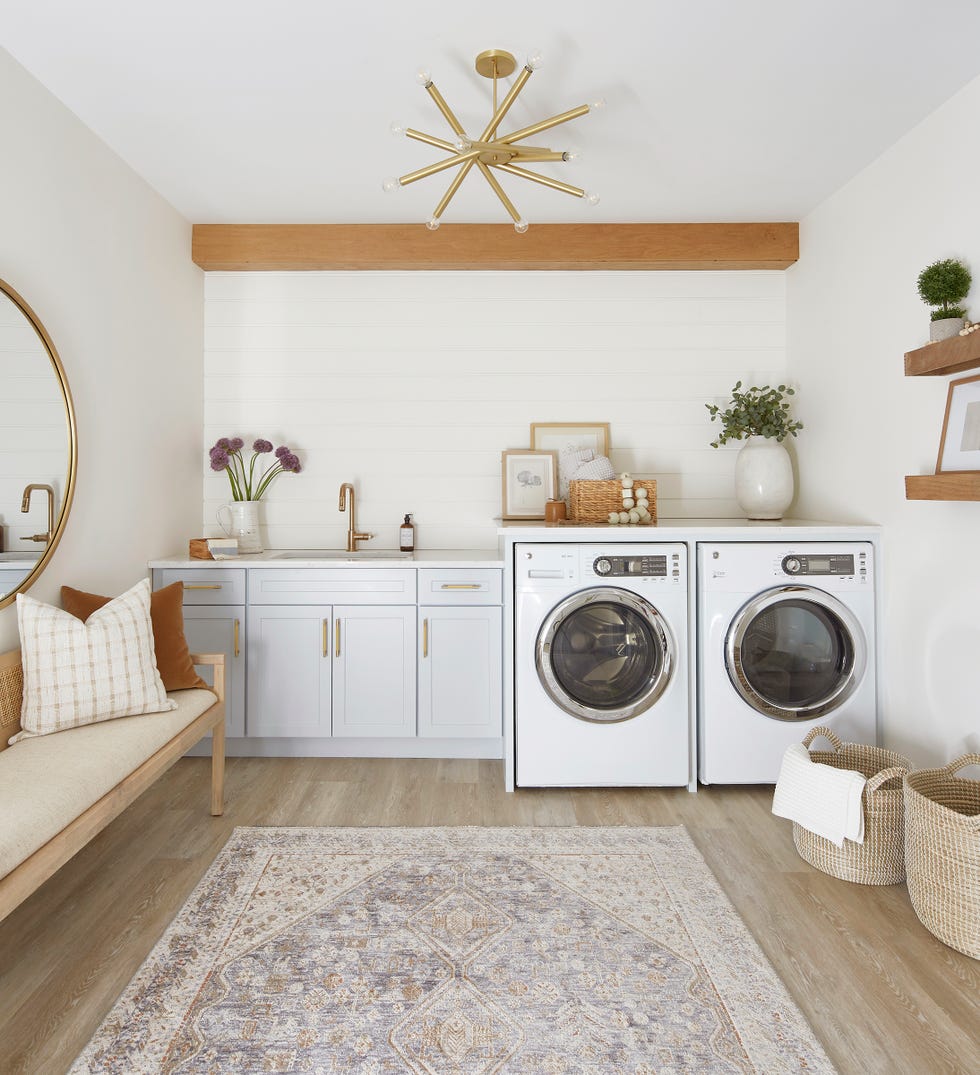 laundry room with cabinets on one end a couch