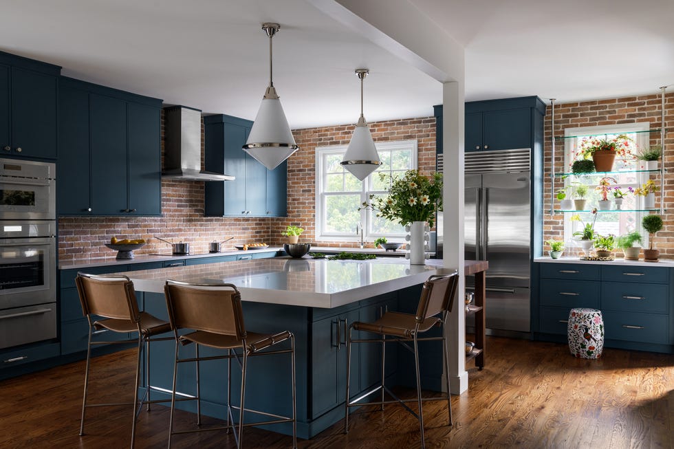 modern kitchen with blue cabinets and brick backsplash