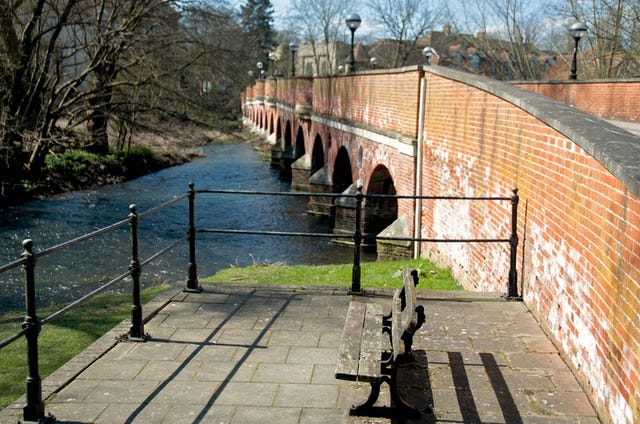 brick bridge over river mole in leatherhead on sunny day