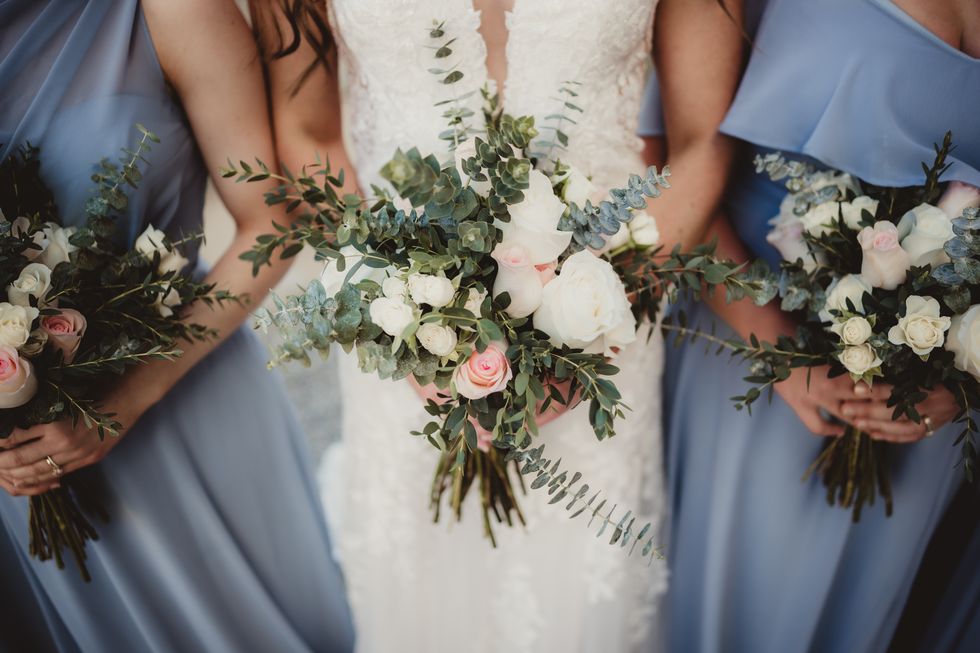 bride and bridesmaids holding bouquets of flowers