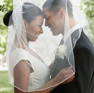 Bride and groom hugging under veil Bride and groom hugging under veil