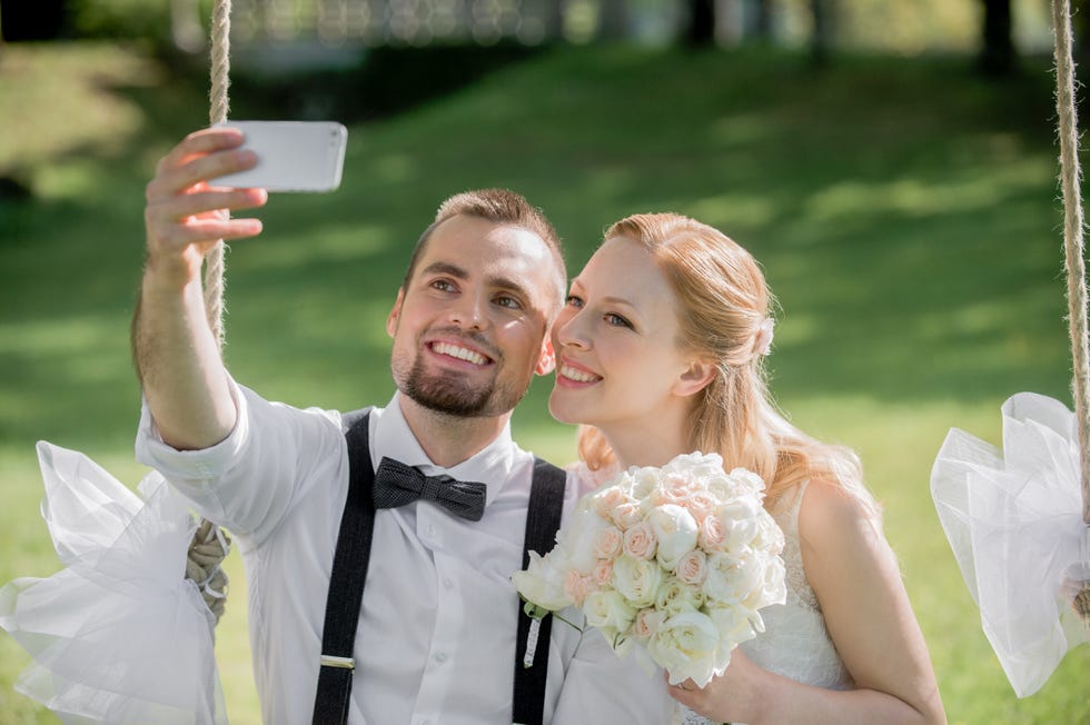 Bride and groom take selfie photo