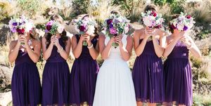 bride with bridesmaid standing with flower bouquets