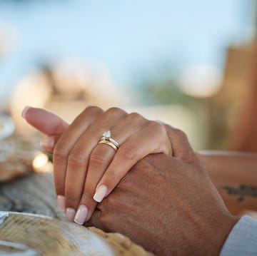 bride with wedding ring holding hand of groom