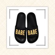 black slides that say babe in gold and white ring dish with gold initial