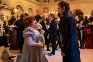 a man and woman dancing in a large room full of people