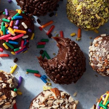 brigadeiros covered in chocolate and rainbow sprinkles, and chopped pistachios and almonds