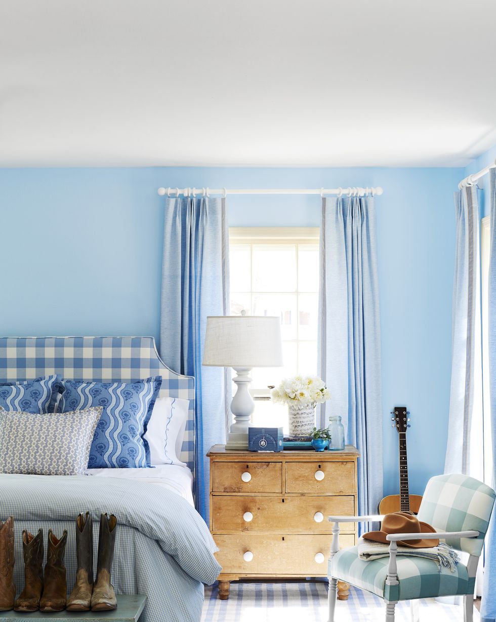 a blue and white bedroom with bright blue walls