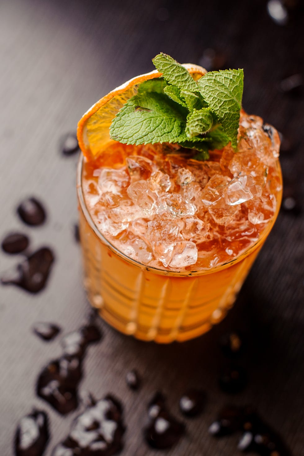 Bright cocktail with mint leaves and an orange slice