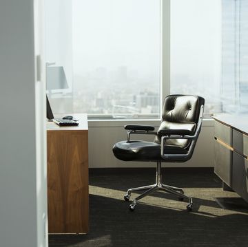 bright corner office space with desk and chairs