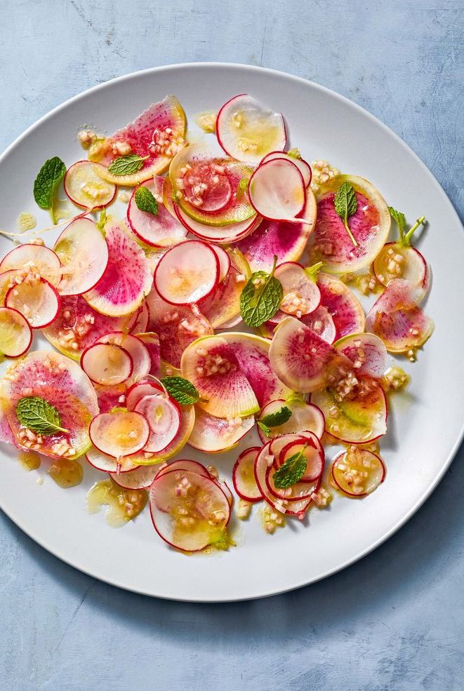 a bright radish salad with mint on a white plate
