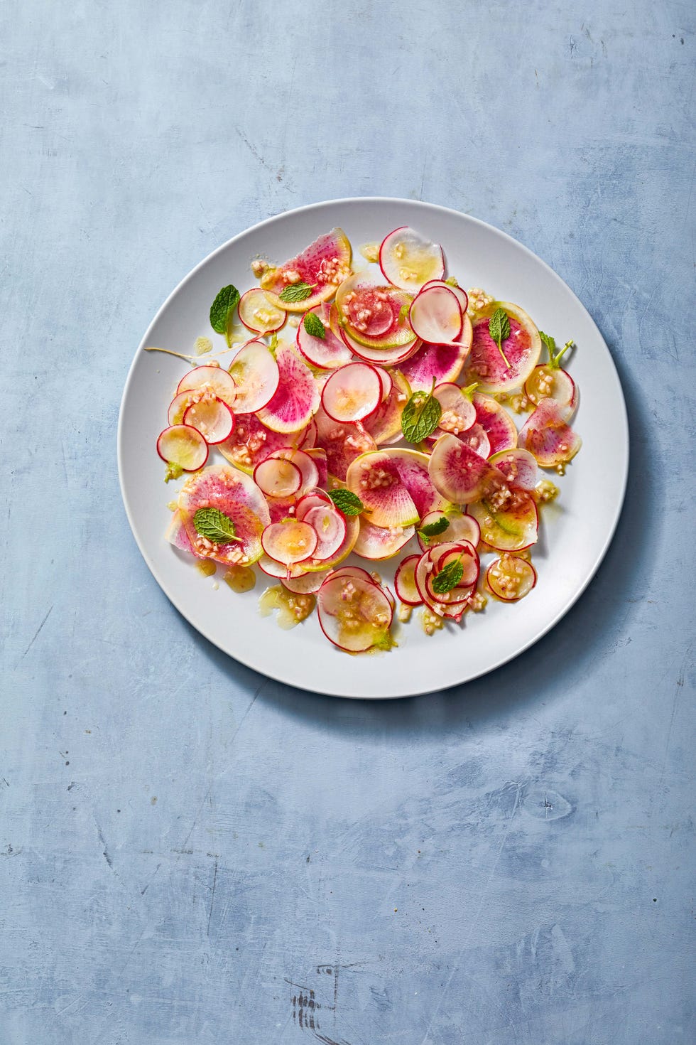 slices of bright radish salad on a white plate