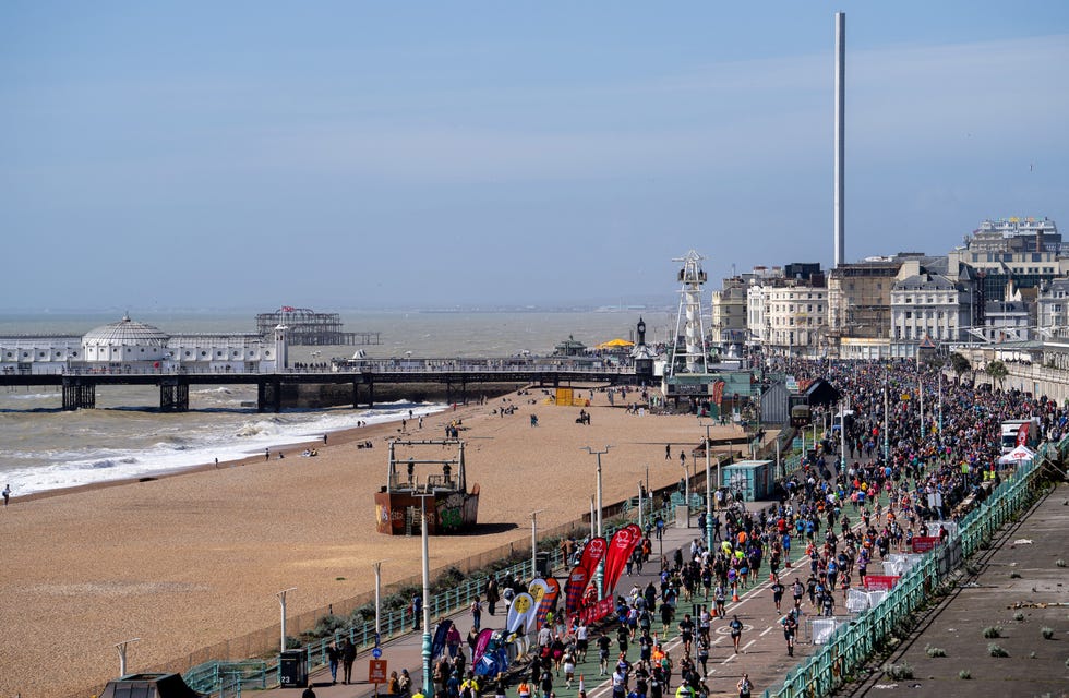 an aerial view of runners in a race along a beach