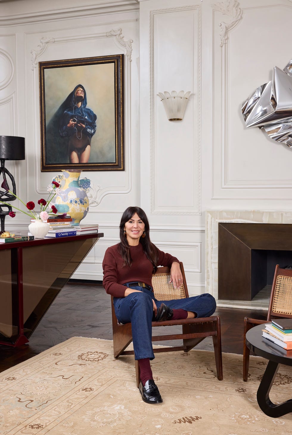 a contemporary living room setting with a person seated and artistic elements
