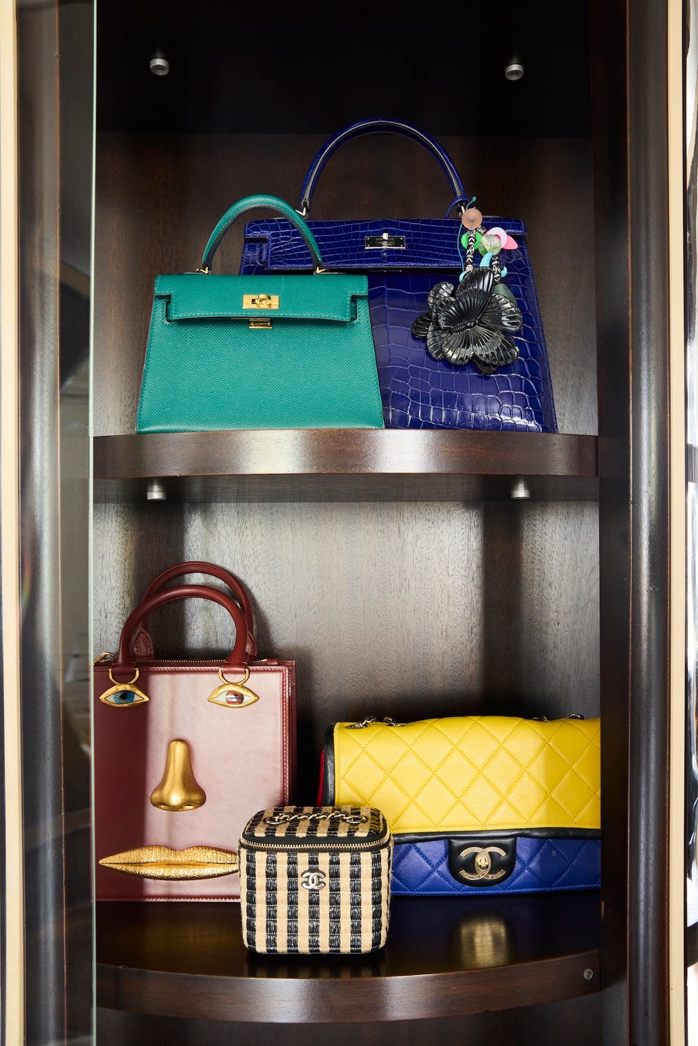 luxury handbags displayed on a wooden shelf
