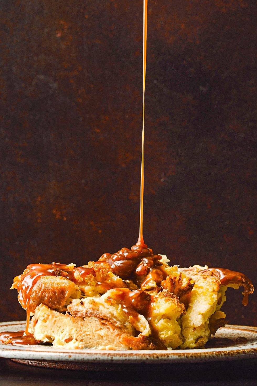 brioche bread pudding with bourbon caramel sauce with long, slow caramel drizzle