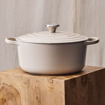 a white and silver le creuset dutch oven
